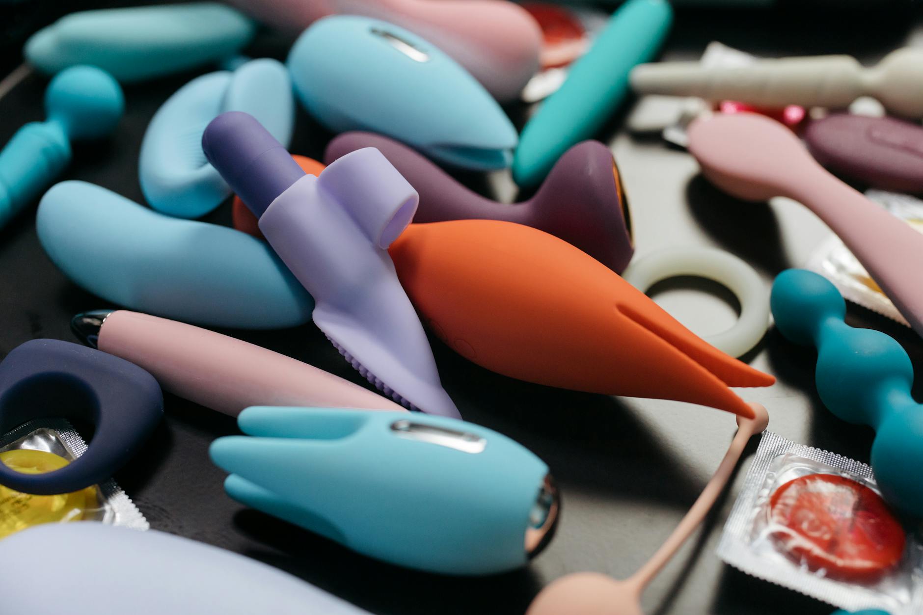 A sleek vibrator resting on soft silk fabric, symbolizing gentle pleasure and comfort